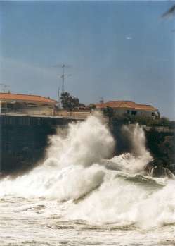 waves breaking below villas